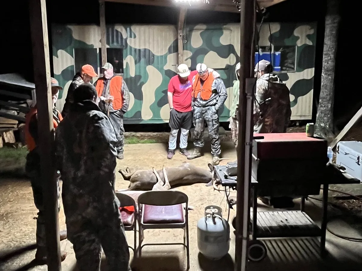 Hunters gathered at deer camp after an evening hunt