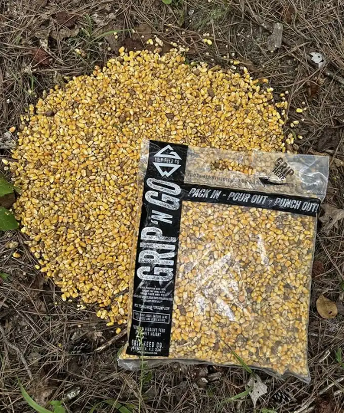 Grip 'N Go bag beside a fresh pour of whole corn on the forest floor