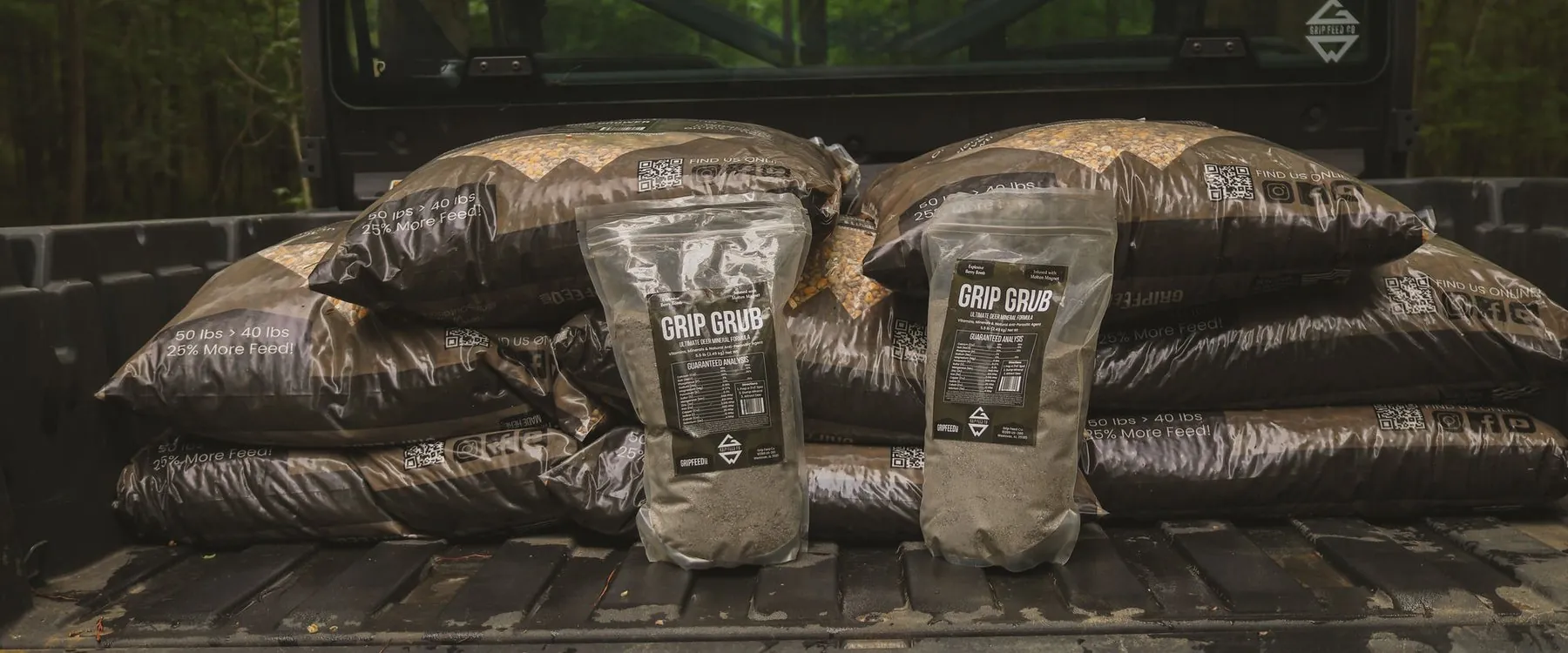 Grip Feed 50 lb bags and Grip Grub mineral loaded in a side-by-side bed