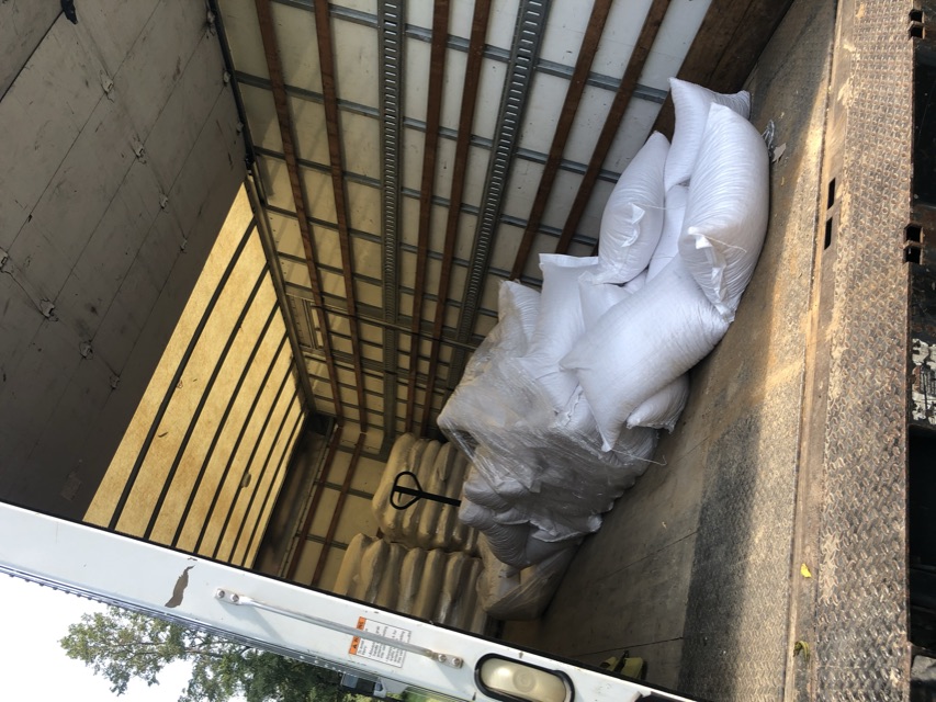 Pallets and bags of feed loaded in a box truck in the early Sterrett days.
