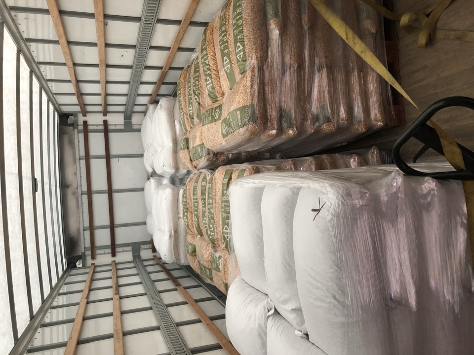 A box truck loaded floor to ceiling with pallets of Triple Grip.