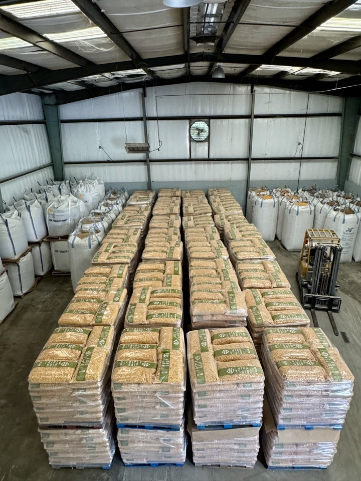 Pallets of Triple Grip staged wall to wall, with totes of peanuts along the sides.