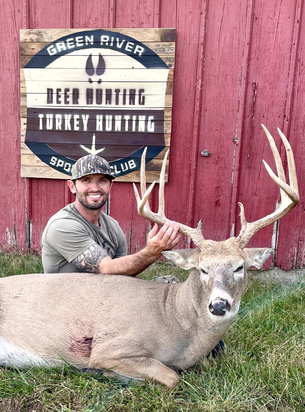Hunter with a mature whitetail buck at the Green River Sportsman Club