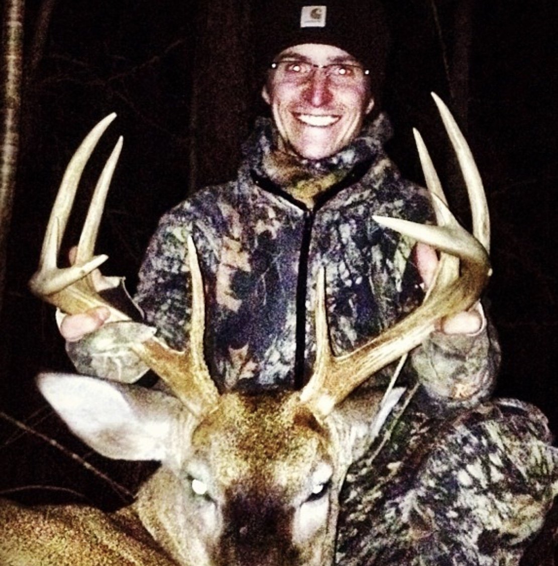 Hunter holding up a tall, wide typical rack