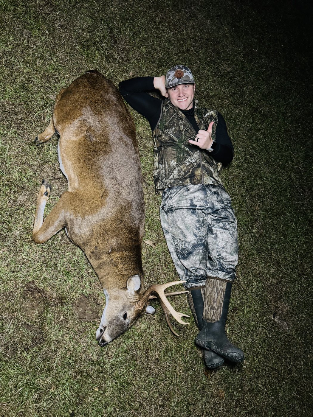 Hunter carrying a whitetail buck out on his shoulders